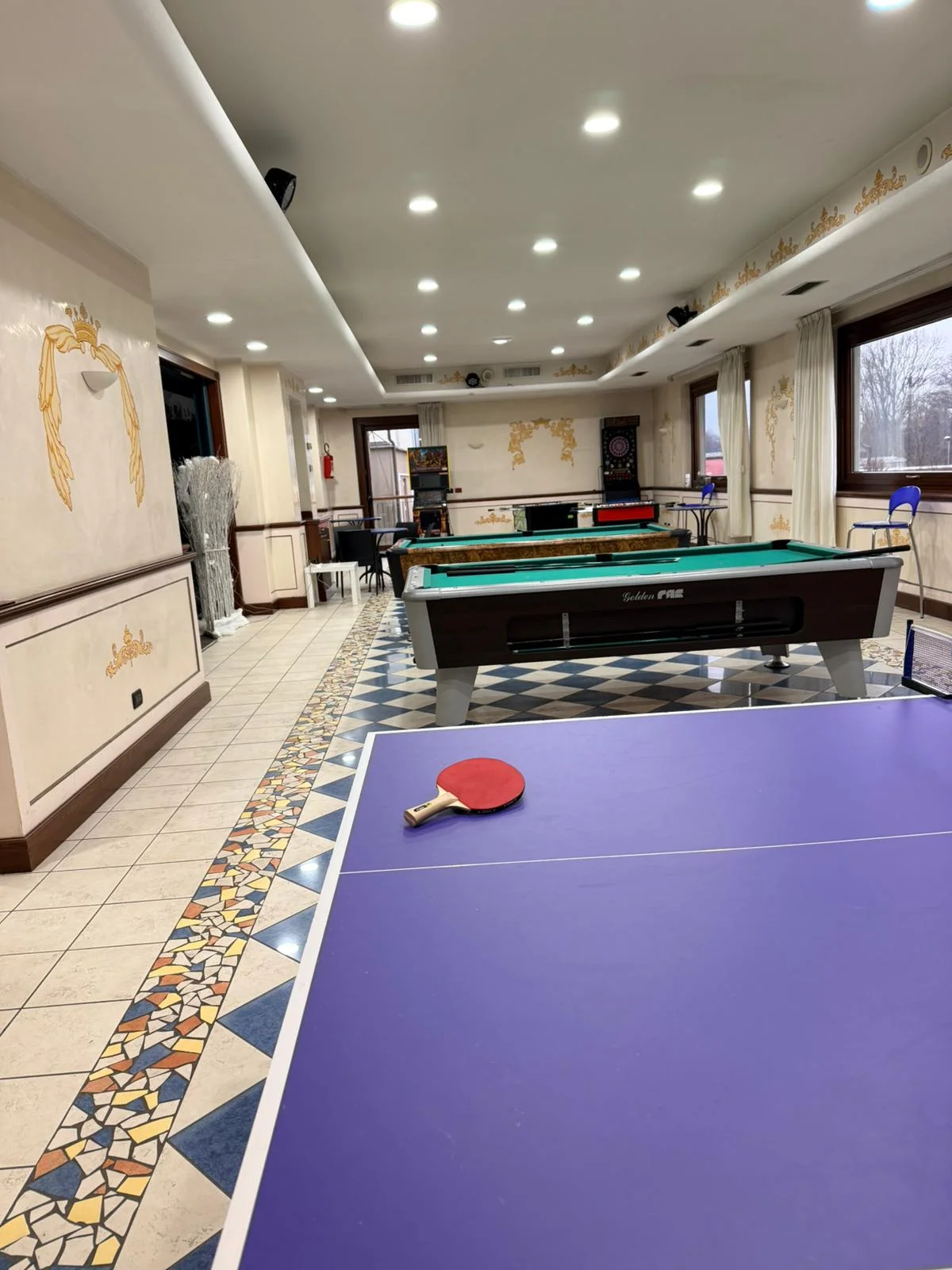 Tavolo da ping pong con biliardo sullo sfondo